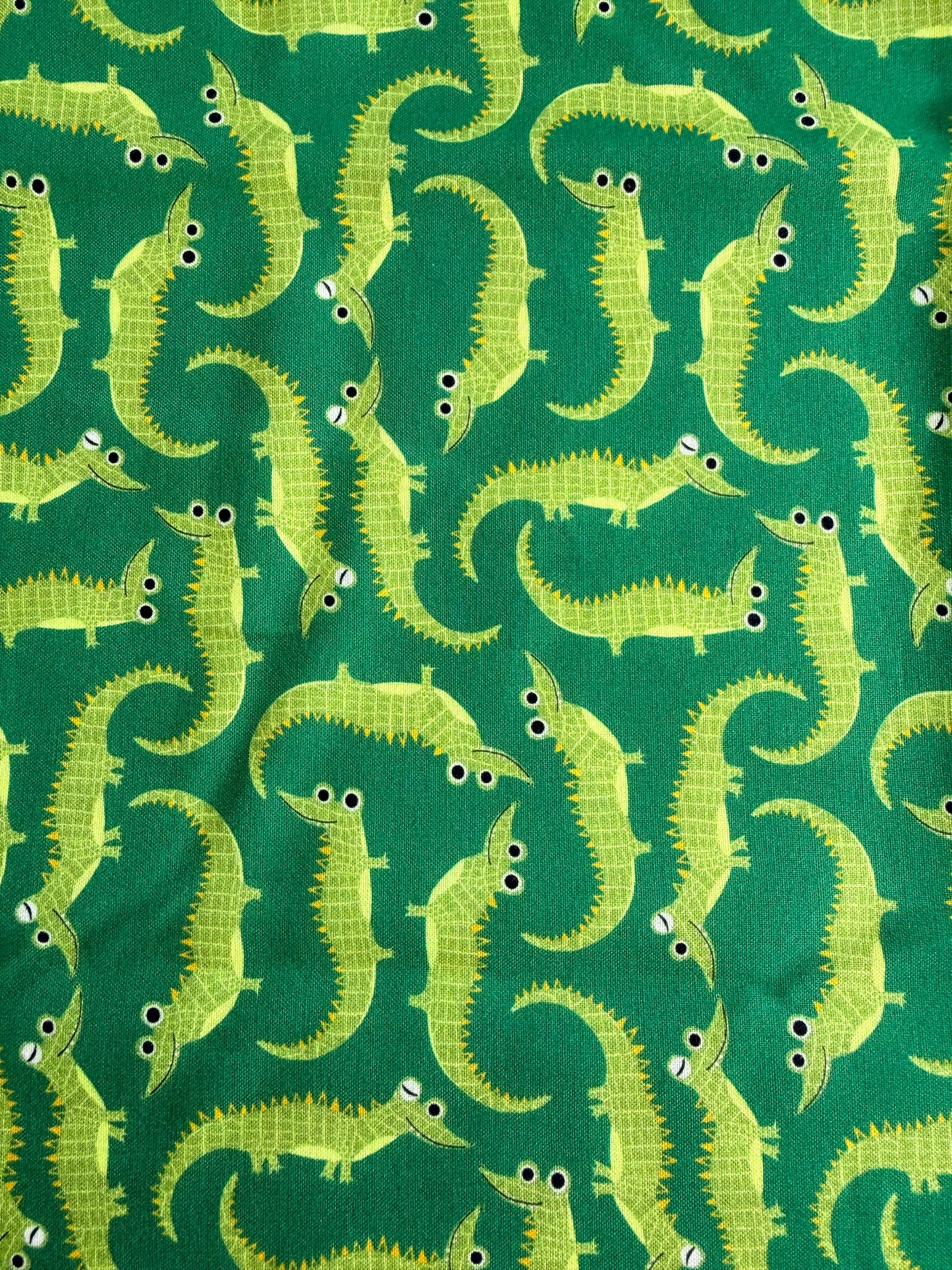 Pattern of green alligators on a green background
