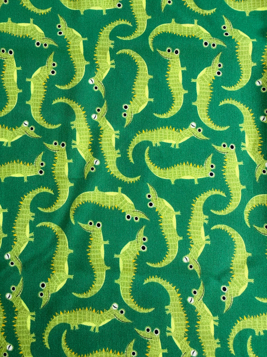 Pattern of green alligators on a green background