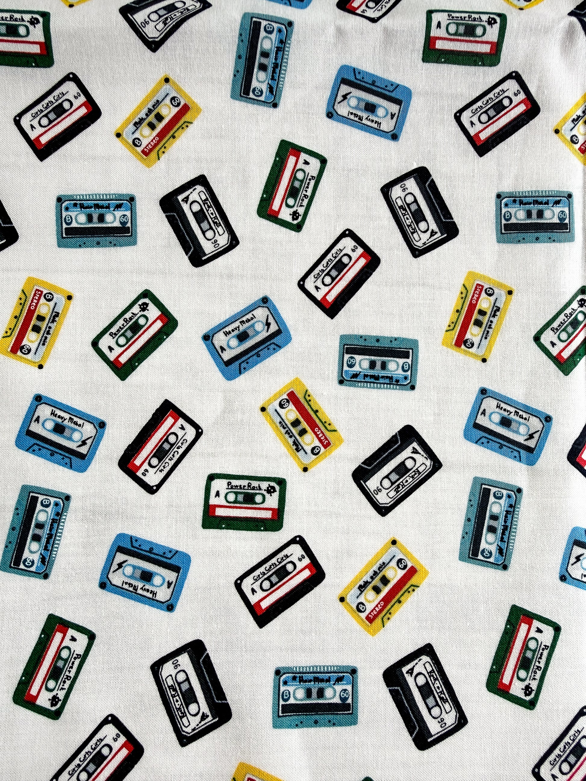 Pattern of colorful cassette tapes on a white background