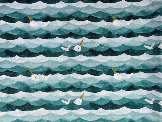 Patterned fabric with wavy lines and narwhal illustrations in teal, gray, and white.